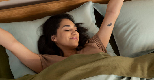 Woman stretching in bed