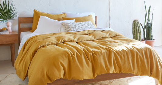 Tuft & Needle bed made with white and gold bedding