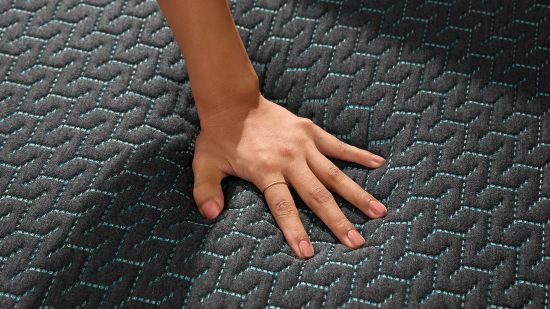 Hand pressing on a mattress
