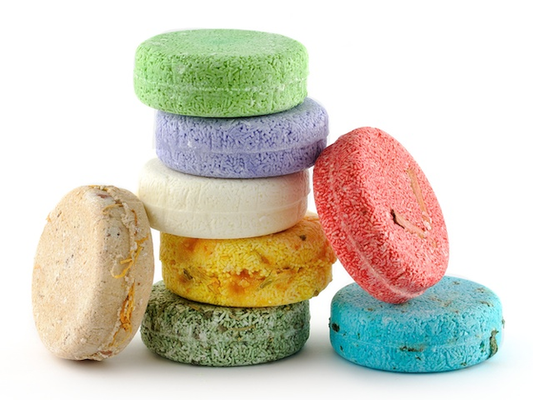 Picture of colorful macaroons stacked on each other. Green, Purple, White, Orange, Cream, Green, Red & Blue