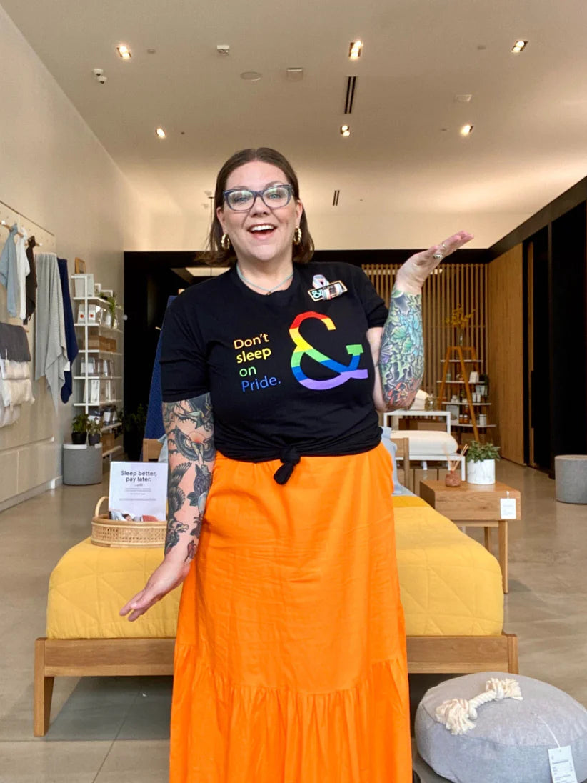 T&N employee in her pride outfit posing in the store