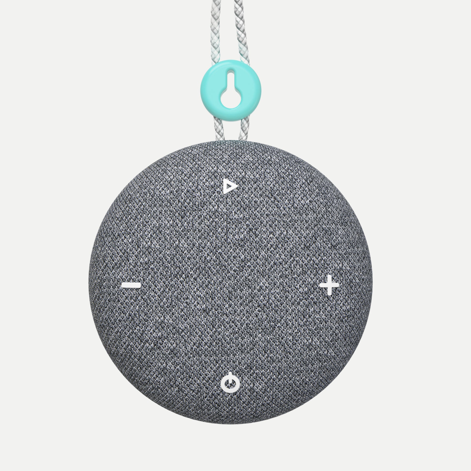 A Tuft and Needle SNOOZ Go 2 Travel White Noise Sound Machine, round gray fabric-covered speaker with white control icons on the front, hanging from a white rope with a turquoise accent ring.