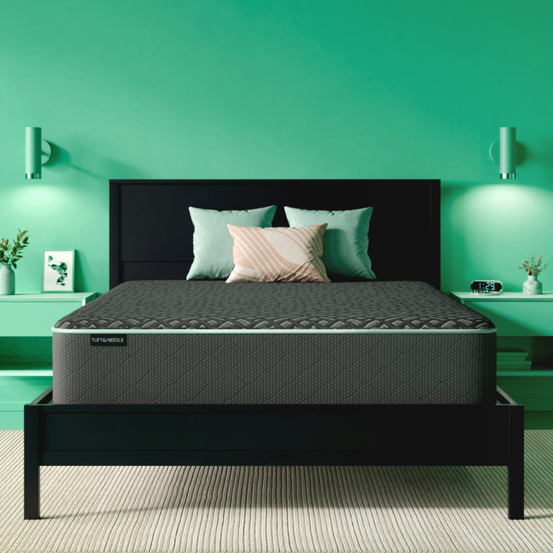 The Tuft and Needle Mint Luxe Hybrid medium Mattress in a green bedroom