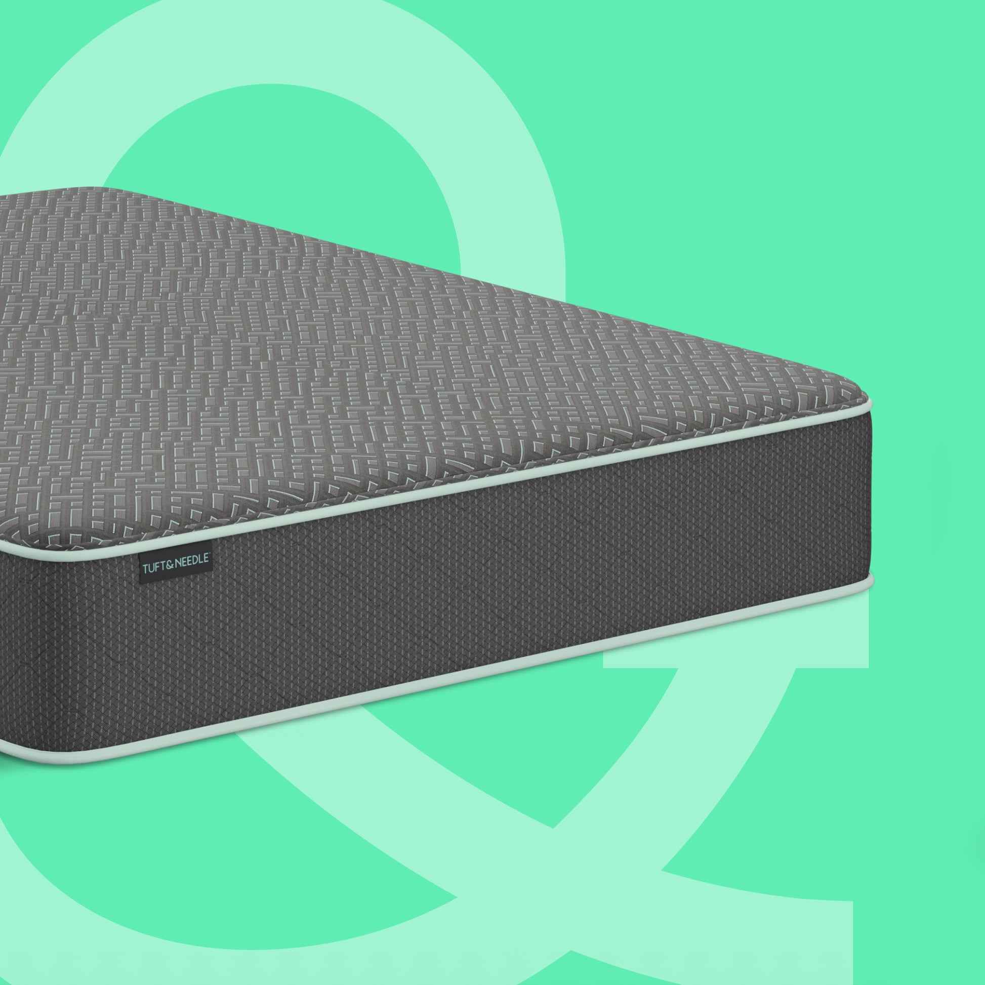 A dark gray textured Tuft and Needle mattress shown at an angle against a mint green background with abstract light green shapes. A small side label reads 'SLEEPABLE'.