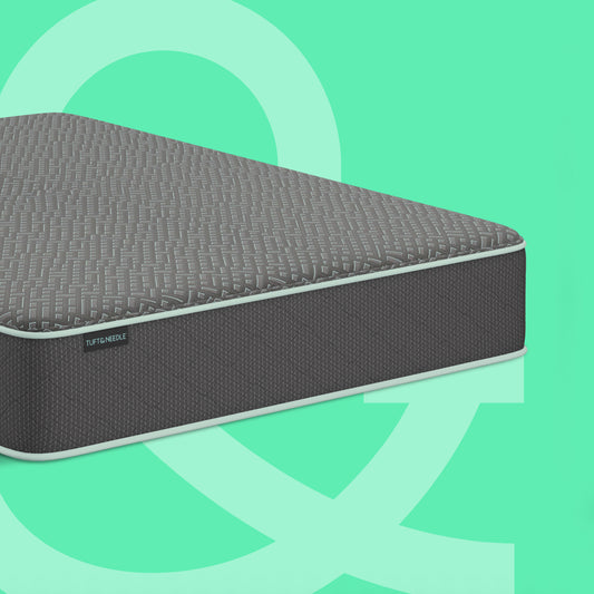 A dark gray textured Tuft and Needle mattress shown at an angle against a mint green background with abstract light green shapes. A small side label reads 'SLEEPABLE'.