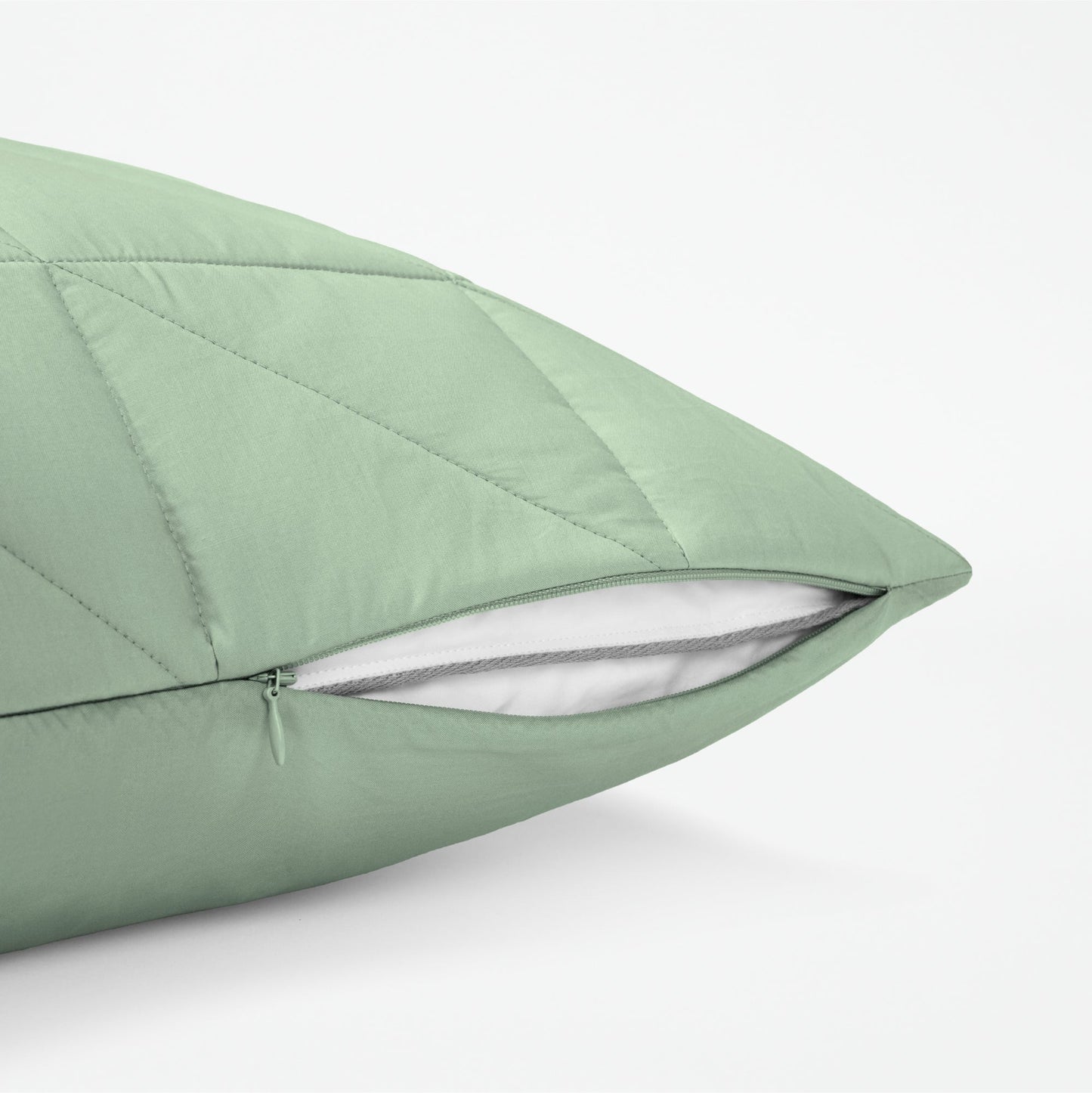 The Tuft and Needle Classic Percale Body Pillow Cover, showing a zipper slightly open to the pillow inside || color: Sage
