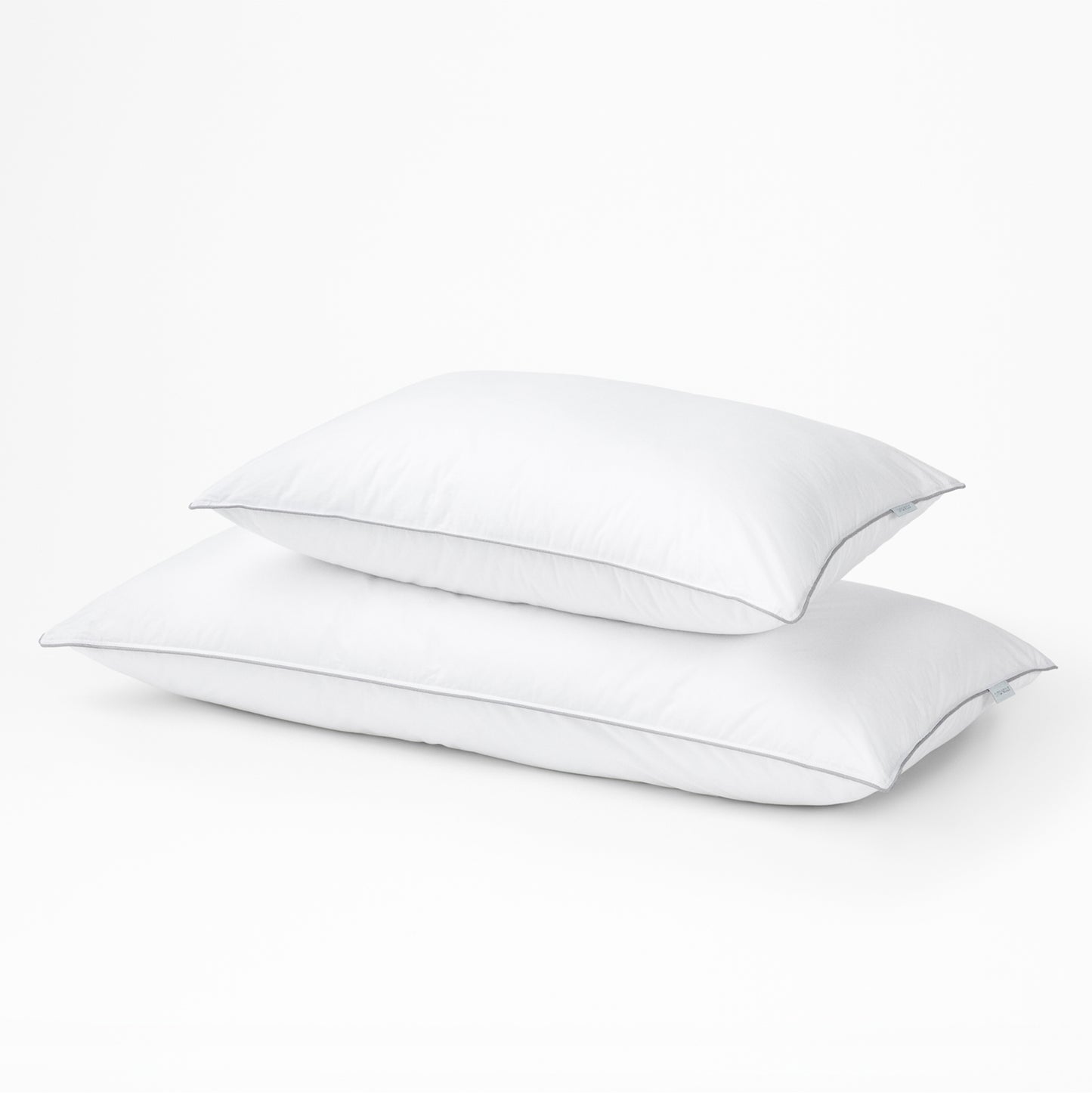 Two white Tuft & Needle pillows on a light gray background