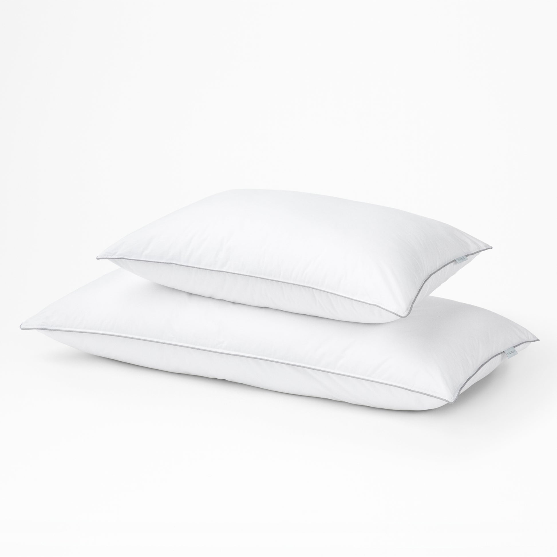 Two white Tuft & Needle pillows on a light gray background