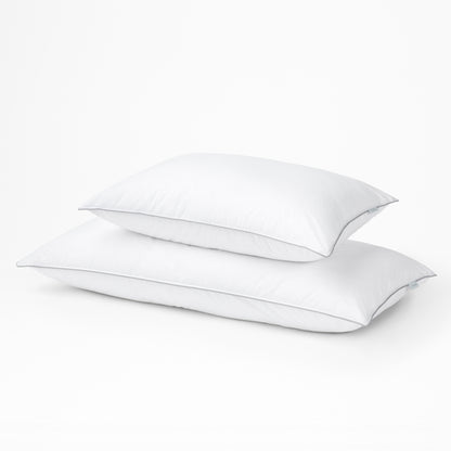 Two white Tuft & Needle pillows on a light gray background