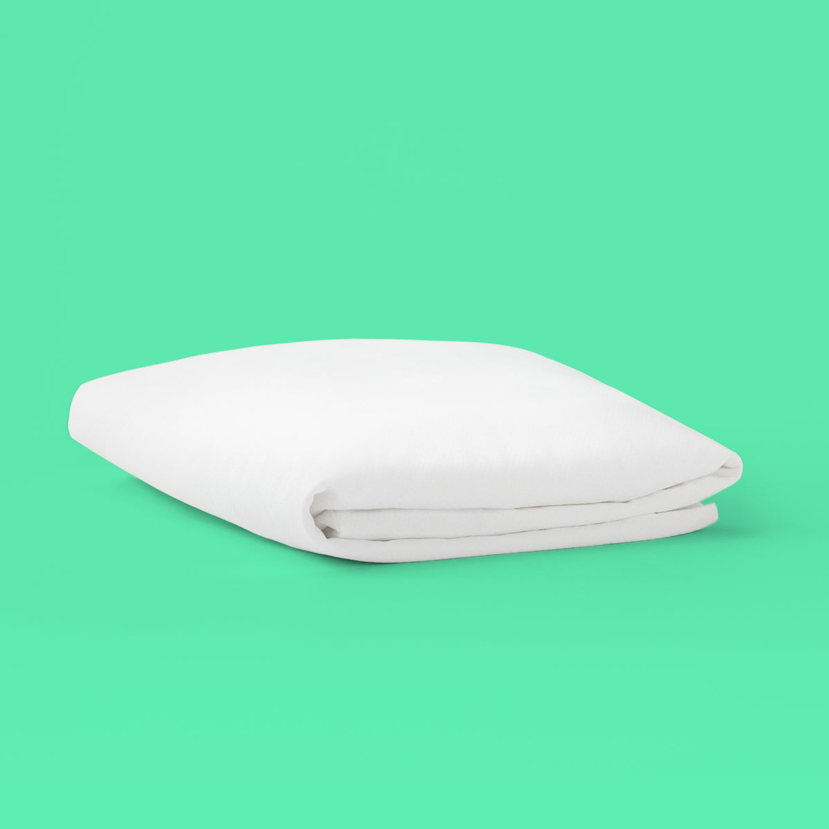 Folded white Tuft & Needle mattress protector