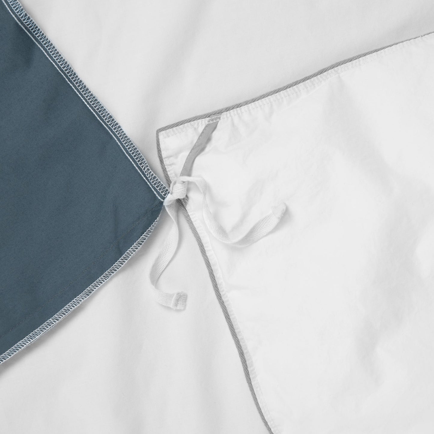 Close-up view of the corner ties on the Tuft and Needle Percale Duvet Cover Set||color:slate
