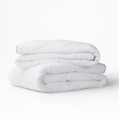 Two Tuft and Needle Alternative Duvet Inserts folded on a white background||weight:medium