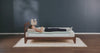 woman rolling on to her side on a foam mattress showing the inside layers of the mattress move