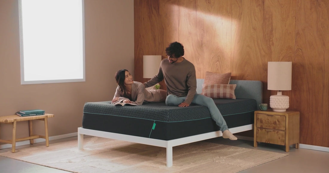 Couple relaxing comfortably, showcasing the support and pressure relief of Tuft & Needle mattresses