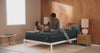 Couple relaxing comfortably, showcasing the support and pressure relief of Tuft & Needle mattresses